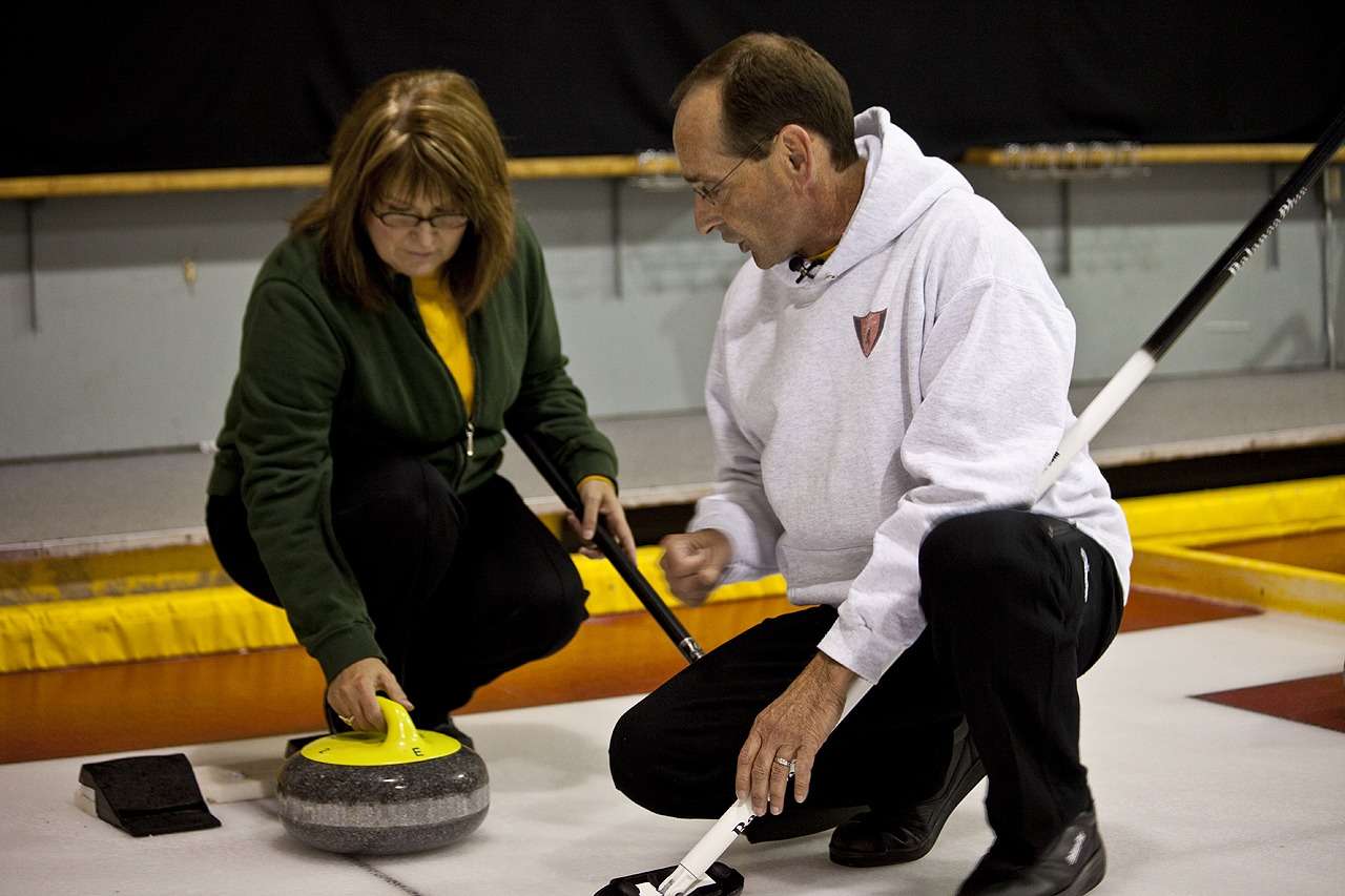 An instructor teaching curling technique